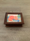 Made In Switzerland Musical Movement Box With An Orange Cat Sitting In A Flower Field With Birds