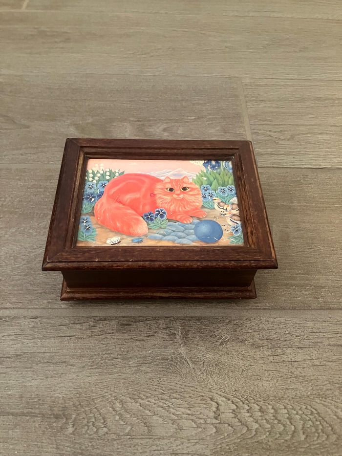 Made In Switzerland Musical Movement Box With An Orange Cat Sitting In A Flower Field With Birds